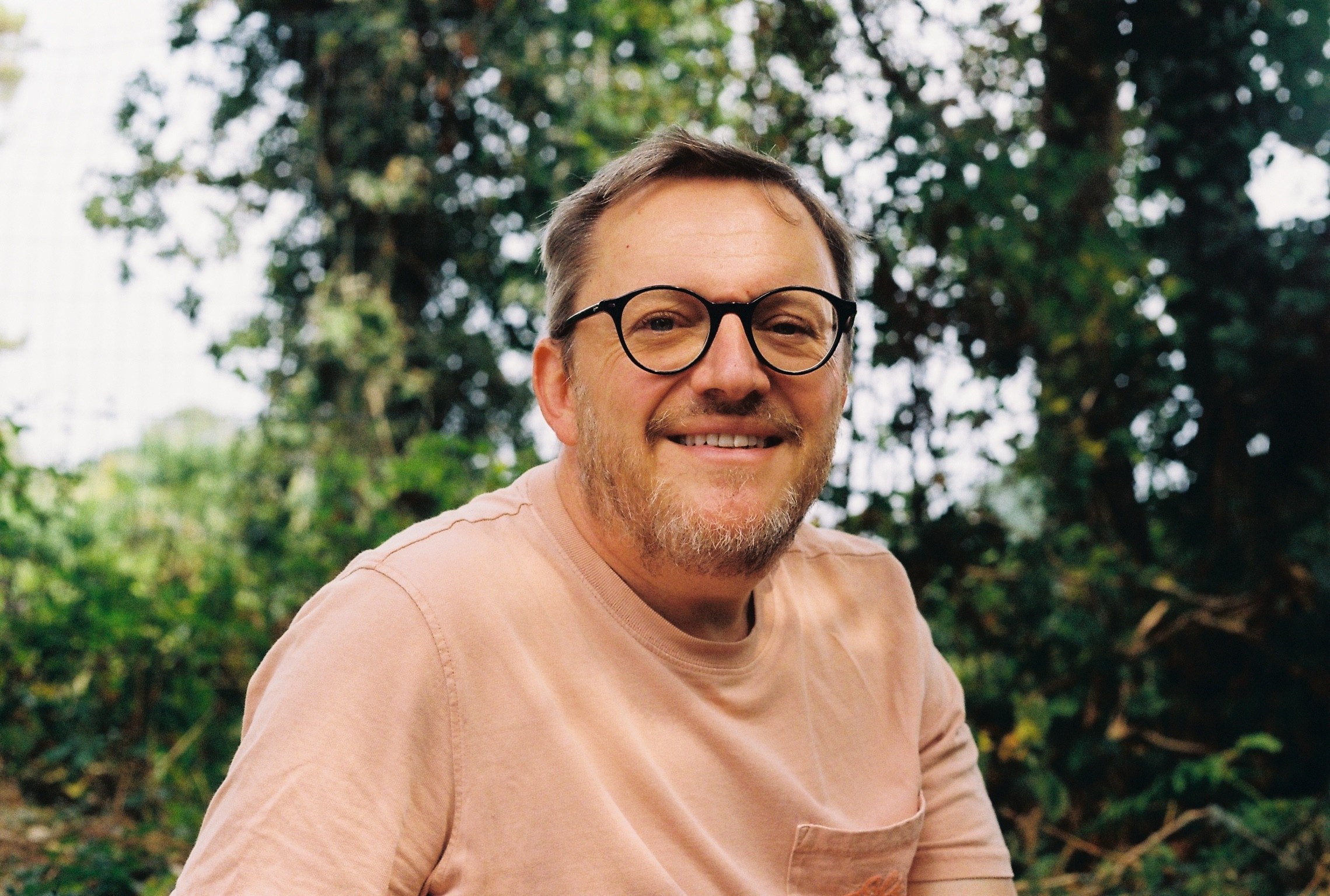 man taking a photo on a wharf